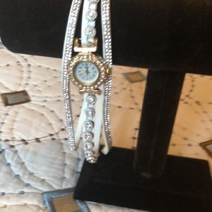 Wrap around watch embellished with crystal stones around watch and band.